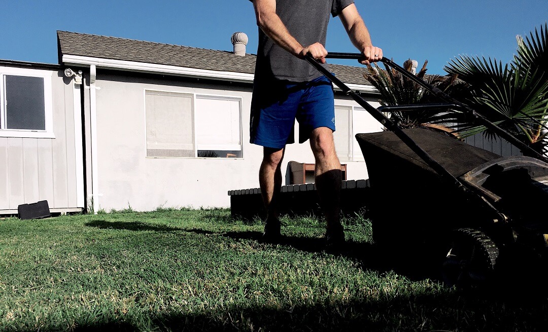 A man mowing his yard